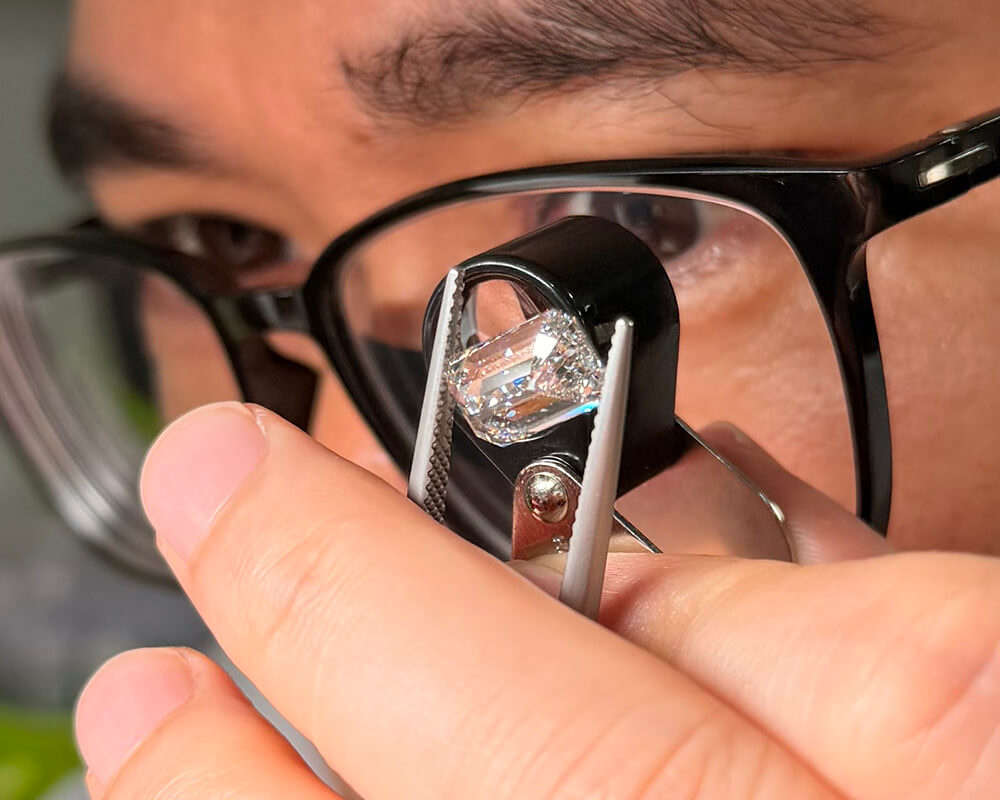 Jeweler selecting loose gemstones for a custom jewelry design