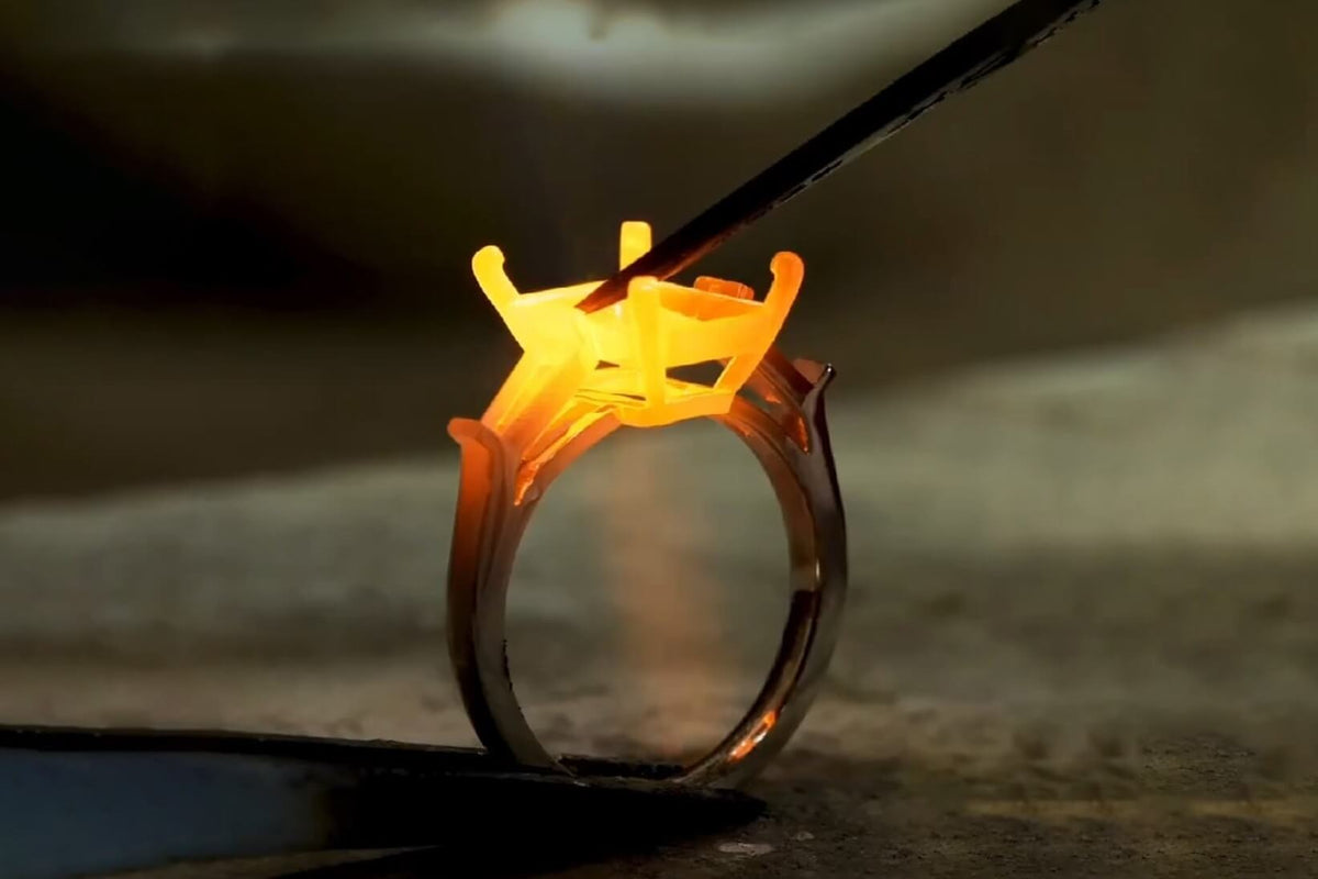 Jeweler welding the custom jewelry setting