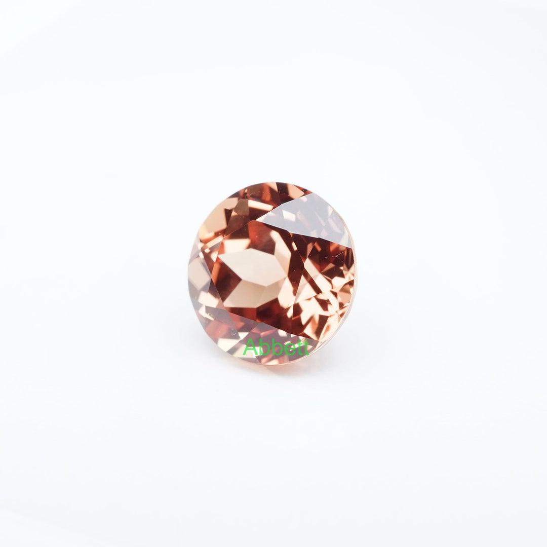 Round lab grown orange sapphire