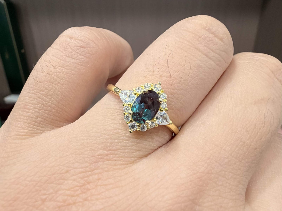 Custom alexandrite engagement ring worn in natural light