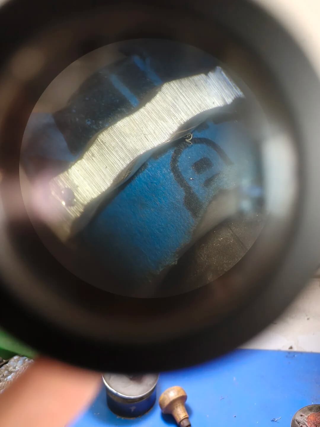 Abbett quality-control specialist inspecting a ring under magnification